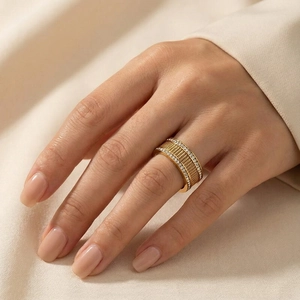 Close-up of gold plated wide band ring featuring double rows of diamonds and mesh pattern