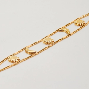 Elegant gold double-layer stainless steel bracelet featuring sun and moon star charms