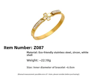 Detail showing 18k gold plated stainless steel clover bangle with zircons and shell