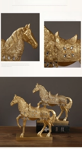 Detail of golden horse resin sculpture with intricate embossed patterns and faux jewels