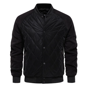 Detail of men's black quilted jacket with raglan sleeves and metal snap buttons