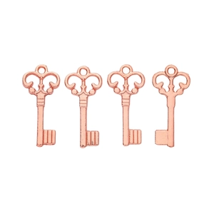 Detailed view of four vintage rose gold key pendants with intricate metal craftsmanship