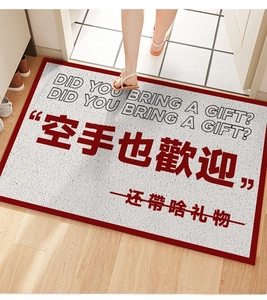 Detail of grey entryway mat with red border and funny text on home flooring