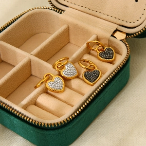 Gold stainless steel heart earrings with white and black crystals in a green velvet box
