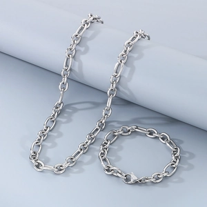 Detailed macro view of silver stainless steel Figaro chain necklace and bracelet set