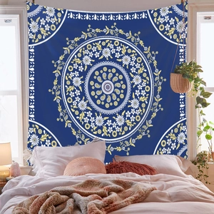 Deep blue mandala tapestry with yellow floral patterns hanging as bedroom wall decor