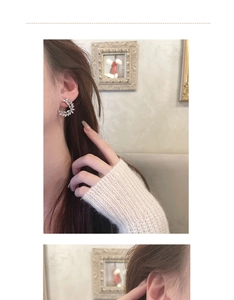 Close-up of elegant silver crescent ear studs with zircon stones worn by a model