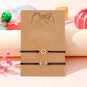 Detail of sun and moon friendship bracelets on English sentiment card with gift decor