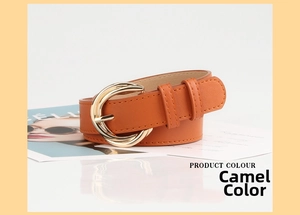 Detail of camel faux leather belt with a golden double round buckle on a soft white surface