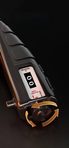 Macro view of digital counter with LCD screen and gold dual-way reset rotation knob