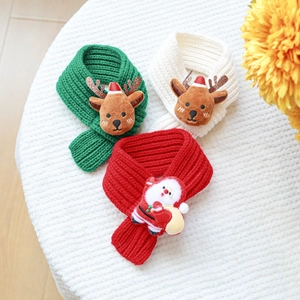 Detailed shot of Christmas knit scarves for pets with Santa and reindeer plush figures