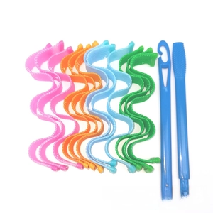 Set of colorful spiral heatless hair rollers in pink, orange, blue, and green with hook tools