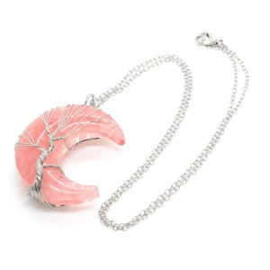 Detailed view of pink crescent moon pendant necklace with silver wire wrapped tree of life