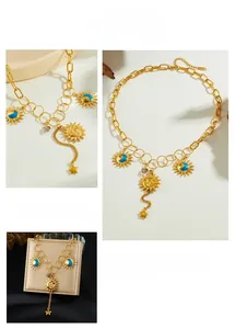 Macro detail of gold sun and blue moon charms on an asymmetric stainless steel chain