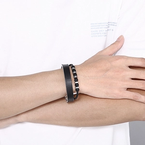 Detail of men's double-layer leather bracelet with black beads and stainless steel beads