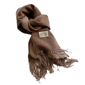 Fashionable color-block cashmere scarf in brown with elegant fringe on a white background