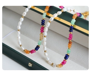 Close-up of handmade baroque freshwater pearl necklace with multi-colored gemstone beads