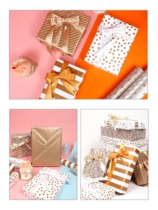 Close-up of gold foil gift wrap with polka dots and stripes including decorative ribbons