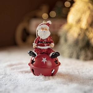 Christmas Santa Claus sitting on a red iron bell ornament for holiday tree decoration