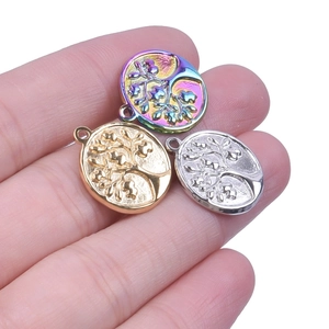 Close-up of tree of life pendants in rainbow, gold, and silver stainless steel
