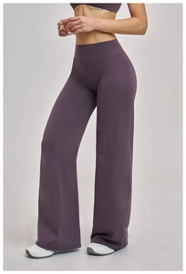 Detail of high-waisted wide-leg yoga pants in deep purple with premium elastic fabric