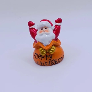 Miniature Santa Claus figurine emerging from a festive Merry Christmas bag detail