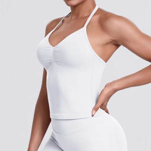 Detail of white seamless yoga tank top showing elastic thin straps and ruched chest design