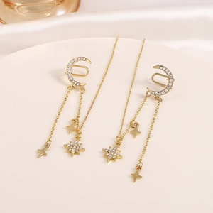 Elegant gold moon and star tassel earrings with zircon studs on white ceramic