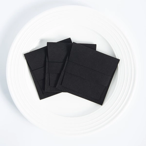 Three premium black microfiber jewelry pouches with flap closure on white tray