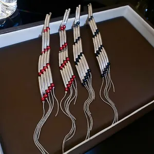 Silver fringe earrings featuring geometric metal tubes and long snake chains with beads