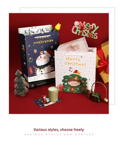 Detail of blue and white Christmas paper gift bags with snowman and tree patterns
