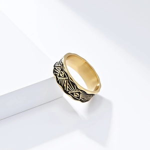Macro detail of gold Eye of Providence ring with black enamel engraving and polished finish