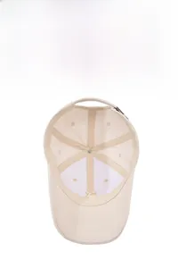 Detail view of the beige baseball cap interior with breathable lining and metal buckle