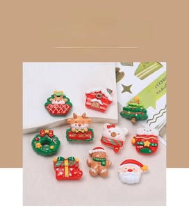 Flat lay of 10 festive Christmas resin charms including Santa and reindeer for DIY crafts