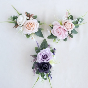 Wedding boutonniere set with rose flowers and pearls in white pink and purple colors