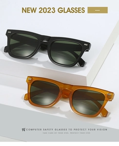 Close-up of black and amber square frames with metallic rivets and protective lenses