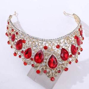 Detailed close-up of Baroque gold crown with sparkling red pear-shaped crystals