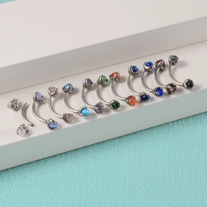 Set of ten stainless steel curved barbells with vibrant multi-color cat eye stone ends