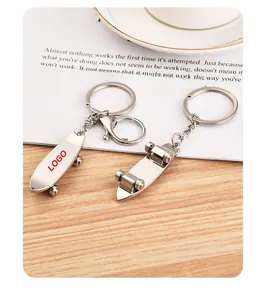 Detailed macro view of metal skateboard keychains showing movable wheels and zinc alloy finish