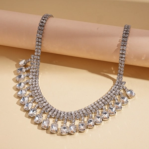 Detail of luxury geometric rhinestone necklace with fringe fringe on pink cylinder display