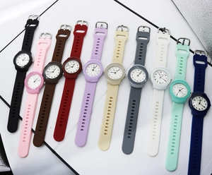 Flat lay display showing eleven colors of round silicone strap fashion quartz watches