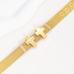 Macro view of adjustable gold stainless steel mesh band with double cross charms
