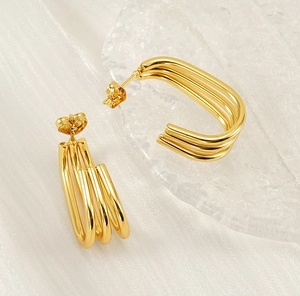 Detailed close-up of triple-layered 18K gold plated C-shaped geometric hoop earrings