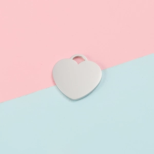 Polished silver heart pendant made of stainless steel for DIY jewelry on colorful background
