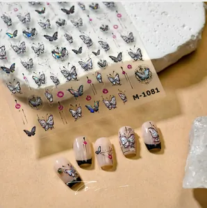 Detail showing vintage butterfly embossed nail stickers and finished manicure application