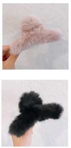 Close-up of soft plush faux fur claw clips in pink and black for autumn winter styling