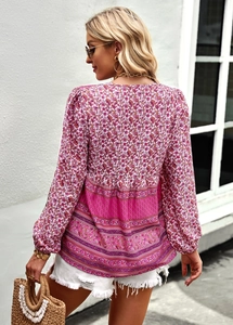 Back view of bohemian long sleeve shirt featuring pink and purple floral print with V-neck
