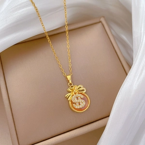 Elegant gold money bag pendant necklace with crystals and orange stone in jewelry box