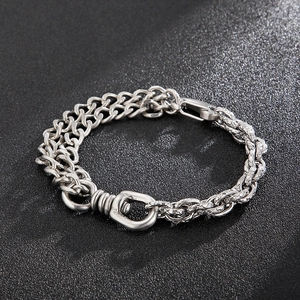 Detail of silver titanium steel bracelet with dual Cuban link and woven chain textures
