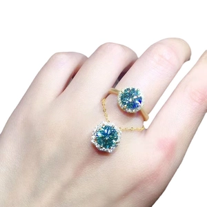 Exquisite 3-carat blue-green moissanite halo pendant and gold-plated ring set on model